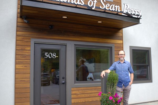 Sean Perry standing outside the door of the new Hands of Sean Perry office