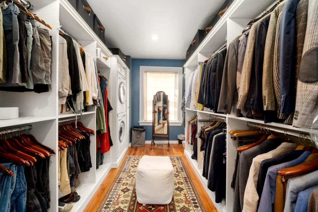walk-in closet remodel with custom shelving and washer dryer